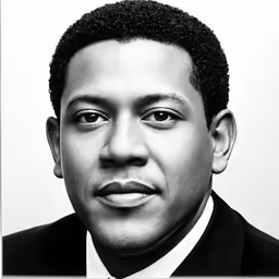 a man in a suit and tie is posing for the camera