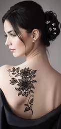 back view of woman with tattoo of a flower