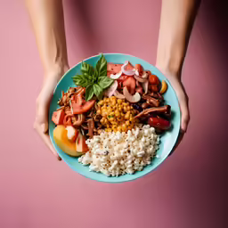 a plate of food sits on the table in someones hands