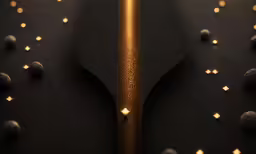 gold colored object laying on top of a black surface
