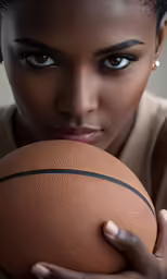 a close up of a person holding a basketball