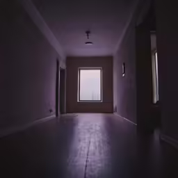 dark room with an open window and hard wood flooring