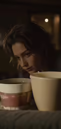 a woman leaning on her stomach and holding a drink