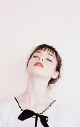 a woman is smiling while looking up at the sky