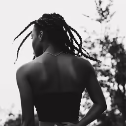 woman with dreadlocks, facing away and left of camera