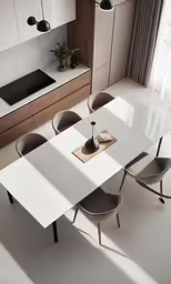 the white table and chairs are near the kitchen counter