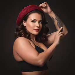 woman with tattoos, wearing a red beret hat
