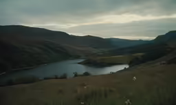 there is a lake on the hill overlooking the countryside