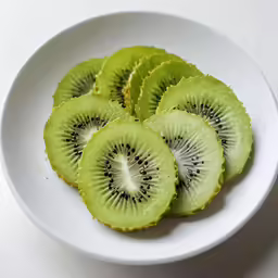 four pieces of kiwi are placed in a bowl