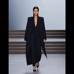 a woman in a black jacket and dress