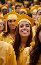 young girls wearing yellow graduation gowns are posing for a photo