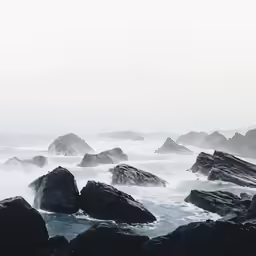 some big rocks in the middle of the ocean