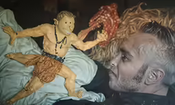 a man laying down looking at another guy