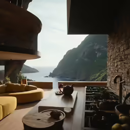 a kitchen with a dining table overlooking the ocean