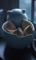 the white bowl is holding three pears on a table