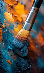 a wet paintbrush with yellow and blue colors