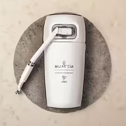 a white cell phone sitting on top of a plate