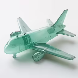 toy glass model of a large airplane against a white background