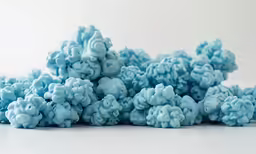 blue cotton balls sitting on top of each other