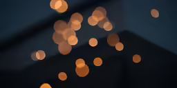 close up of a street light with blurry lights in it