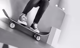 the footwear of a young person riding a skateboard