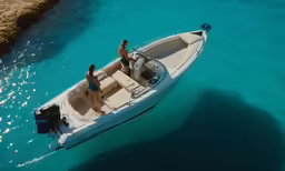 a couple of people standing on top of a boat in the ocean