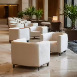 a group of white chairs in a lobby