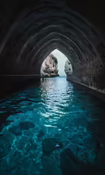 a blue lagoon with rocks, rocks and water