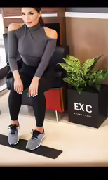 a woman in grey shirt sitting on chair