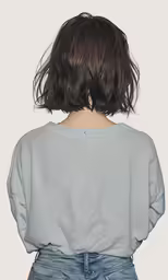 a woman with her hair in the wind and a gray shirt that says, i love to
