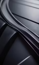 a close up view of black and chrome lines on a car