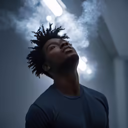 a man with dreadlocks smoking a cigarette