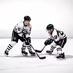 two male hockey players playing ice in front of a white background