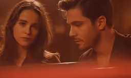 a man looking at his girlfriend in the back seat of a car