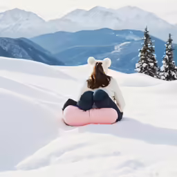 the girl in bunny ears is sitting on the snow