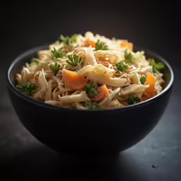 this is a bowl of food that includes noodles and carrots