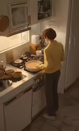 a person is standing at the kitchen sink, looking down at the stove
