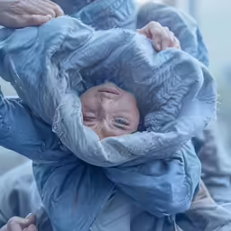 a doll with a plastic head is covered by material