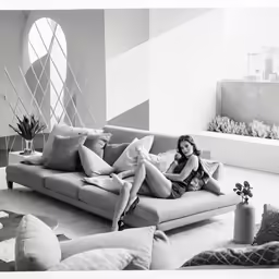 a girl in a white bikini sitting on a couch