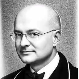 a close up image of a person wearing glasses and bow tie