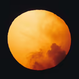 the sun appears to be in the sky with some clouds