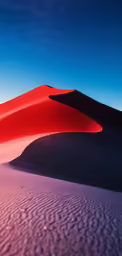 a red sand dune in the desert at night