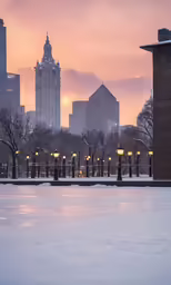 a view of a city from a skating rink at dusk