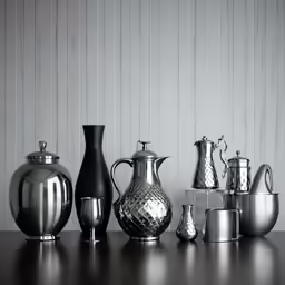 silver vases and other black and white containers