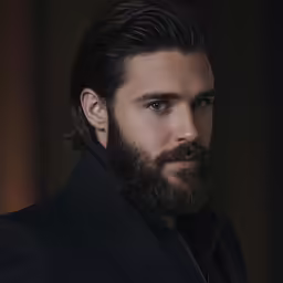 a bearded man with black hair and beard