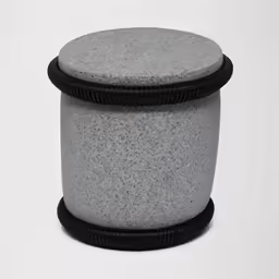 this round object is in cement and black rubber