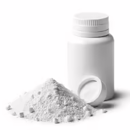 a white bottle and pile of pills next to each other