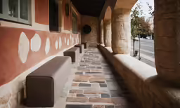 an old stone house with the door in a big long hallway