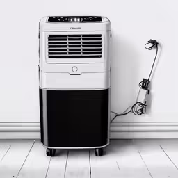 an electric air conditioner is placed on the floor next to a white wall