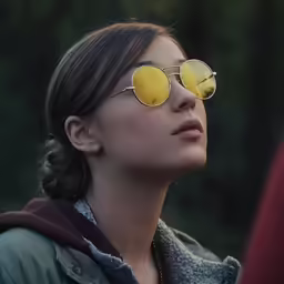 woman with sunglasses looking out of the window